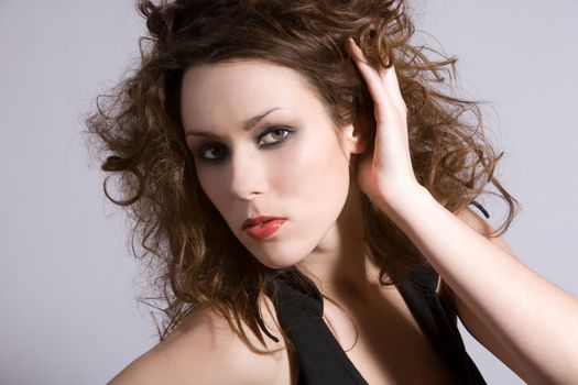 Beautiful brunette with wild hair and heavy makeup