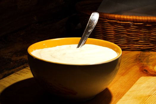 Foto of sour cream placed at ceramic bowl