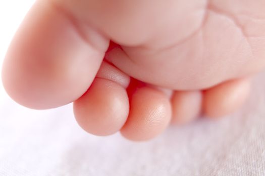 8 days old girls bead looking tiny toes.