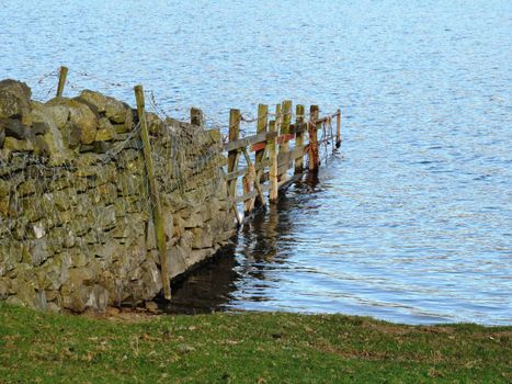 A field dividing wall terminating in a lake