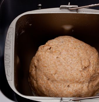 Bread making machine with dough starting to rise with the yeast