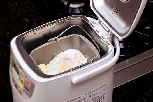 Bread making machine with ingredients prepared for mixing