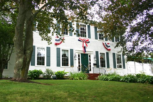 Turn of the century american house with patriotic banners