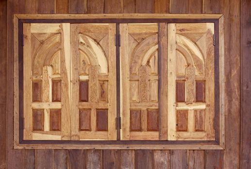 Closed wooden windows of new house at Laos