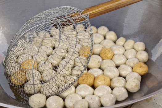 Fish meat ball fry in pan at market of Thailand