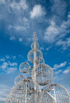 Metal structure christmas treeunder bright blue sky