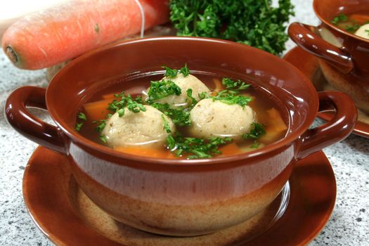 soup clear with bone marrow dumplings and parsley