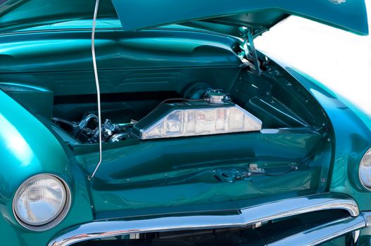 Green classic car engine at car show