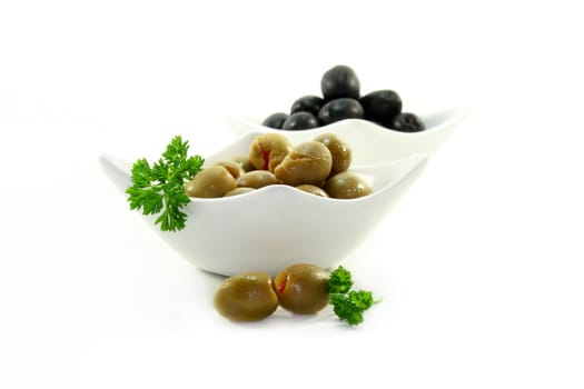 black and green olives in small white bowls