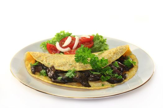 an omelet stuffed with wild mushrooms and fresh salad