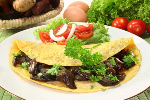 an omelet stuffed with wild mushrooms and fresh salad