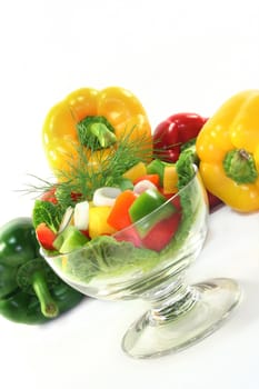 colorful bell pepper salad with dill in small glass bowl