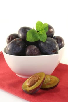 fresh blue plums on a white background