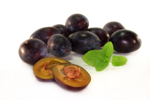 fresh blue plums on a white background
