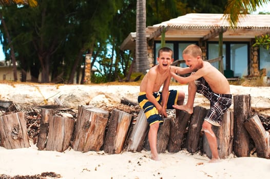 Brothers laughing on the beach