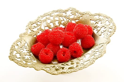 red raspberry in the vintage metal vase