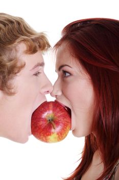 Closeup of young caucasian coupe biting apple over against white background.