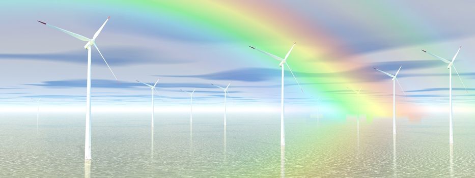 Wind turbines in the blue ocean in front of a beautiful rainbow