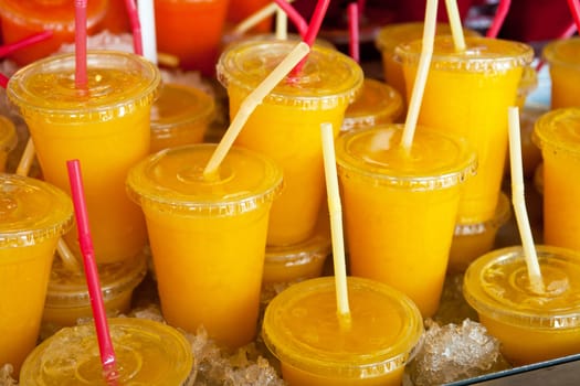 Cold wet freshly squeezed glasses of orange juice for sale