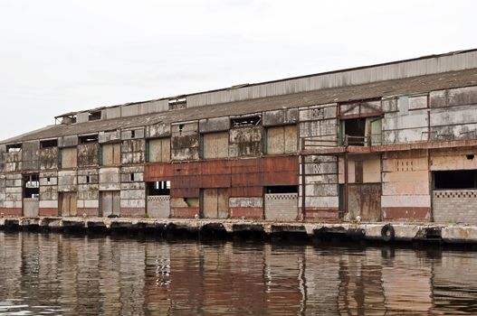 Exterior of an abandoned old rusty industrial building.