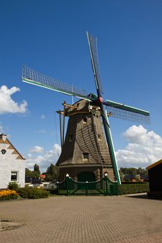 Dutch windmill with blue sky background on sunny summerday