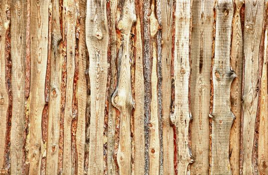 A fence made of rough wooden planks and slabs