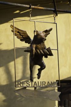 a custom made restaurant sign with a flying pig