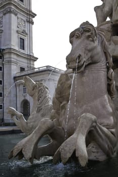 A fountain of a horse with water coming from its nose in Salzburg, Austria.