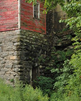 Old Building On A Stone foundation vertically displayed in the summer.