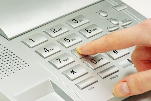 finger with  gray telephone keypad