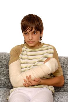 sad teenage caucasian boy with broken arm bone