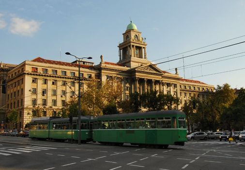 crossroad in Belgrade, Serbia with passing green tram