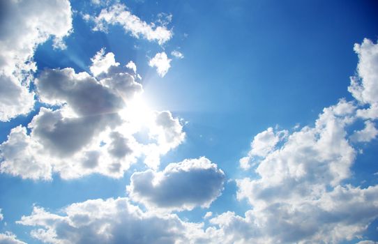 blue sky with clouds and sun