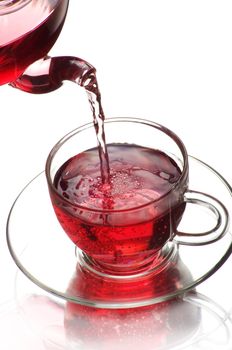 Tea being poured into glass tea cup