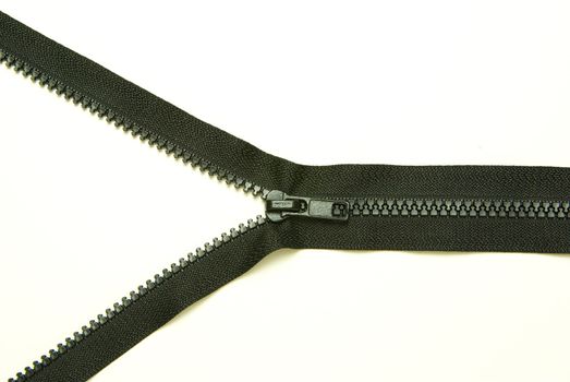 Unzipped  metal zipper on white background