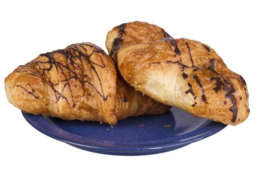 two croissants with chocolate on blue dish