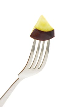 aubergine on fork on white background