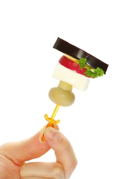 Close-up of canape with olives, cheese and over white