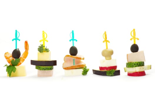 Close-up of canape with olives, cheese and over white