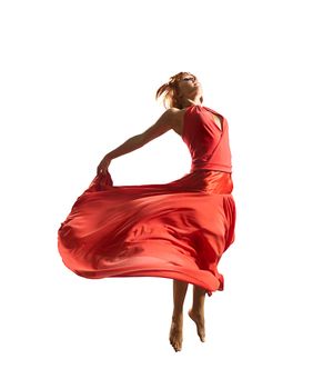 Gorgeous young flying dancer wearing red dress