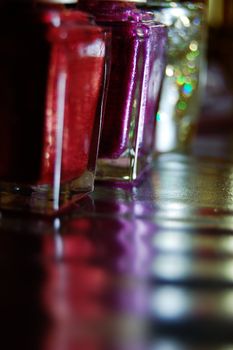 Colorful nail varnish and its reflection