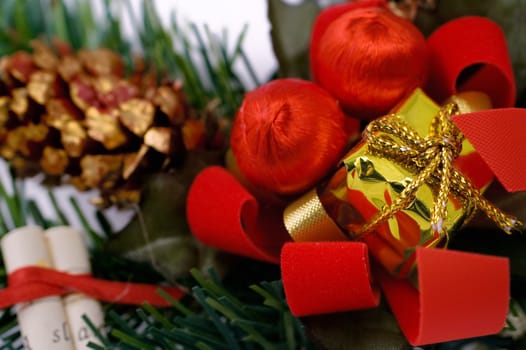 Miniature Christmas gift with other ornaments. Shallow depth of field