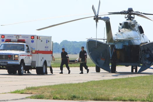 Two soldiers with a hand frame  run to  emergency car during the medical military trainings in Vinnytsya, June 10, 2008. Ukraine