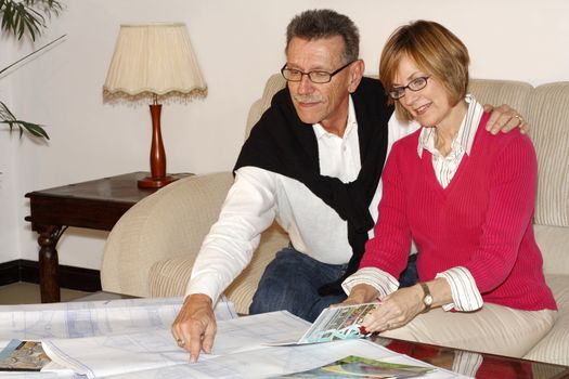 Couple trying to decide how to spend retirement money-travel or retirement home.