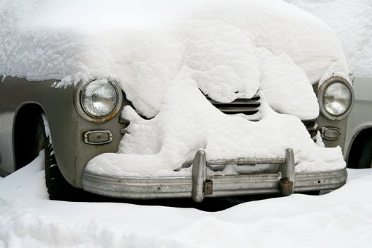 Old car under white snow