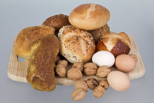 gem, nuts and eggs on a wooden board. neutral background