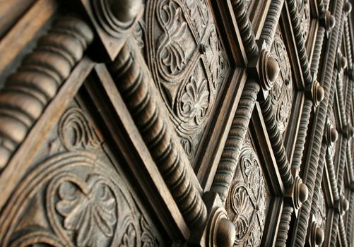 Detail from a beautiful wooden carved door of a church.