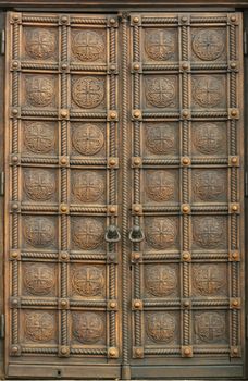 Closed, old carved wooden door.