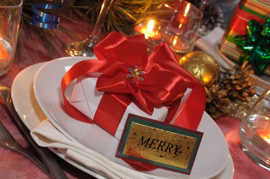 Gift with red bow on a festive table for Christmas