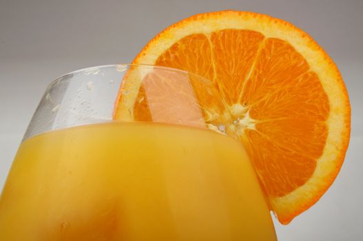 Glass of fresh orange juice with an orange slice